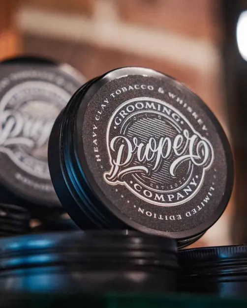 Tins of grooming product on a shelf