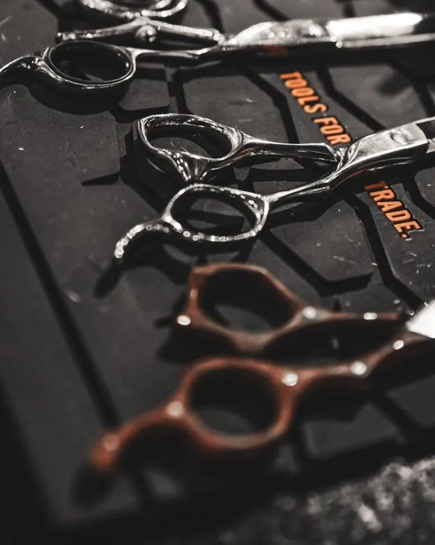 Barber shears laid out on a mat