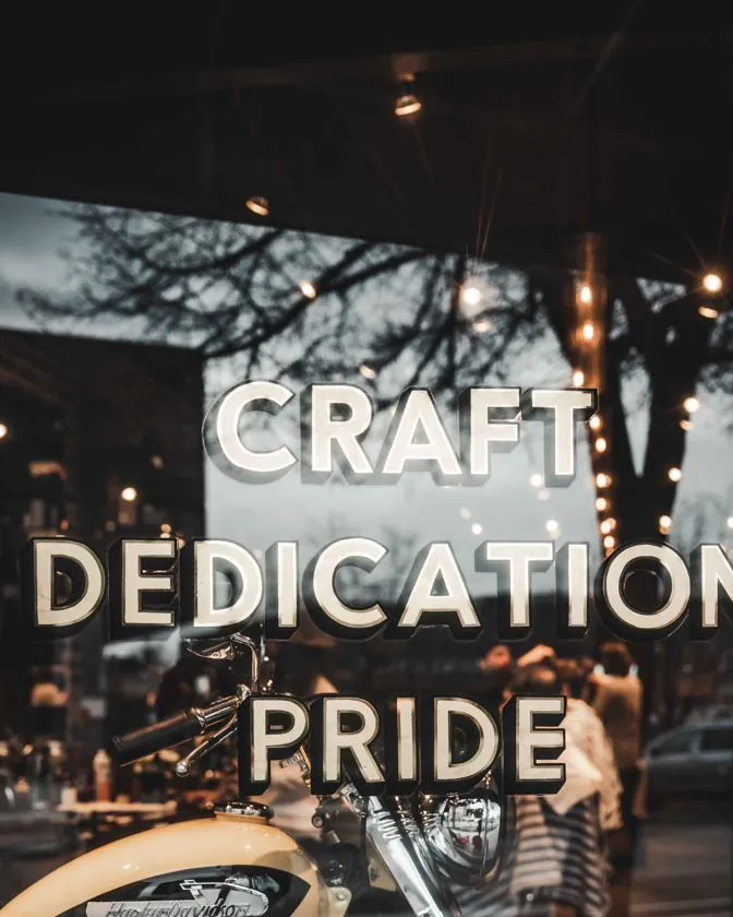 Gold “Craft, Dedication, Pride” lettering on the shop window