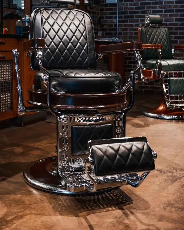 A black barber chair on the shop floor