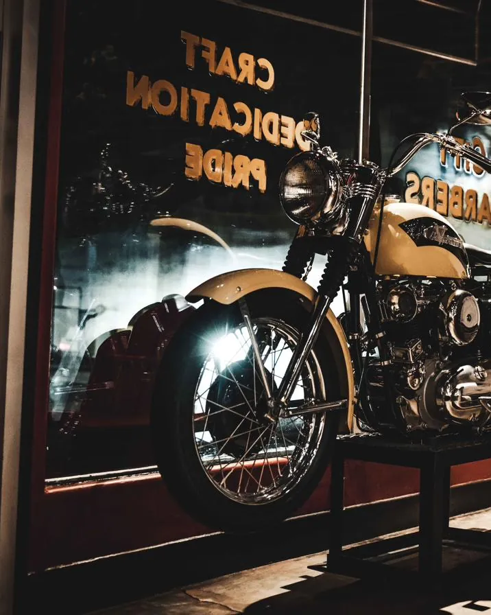 A vintage motorcycle displayed in the shop window