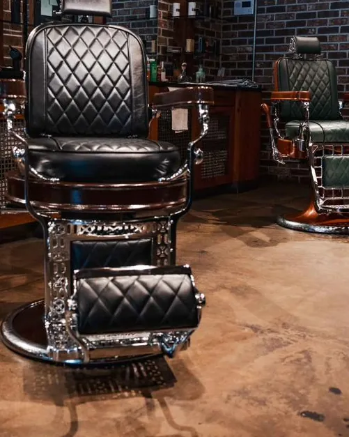 A black barber chair on the shop floor