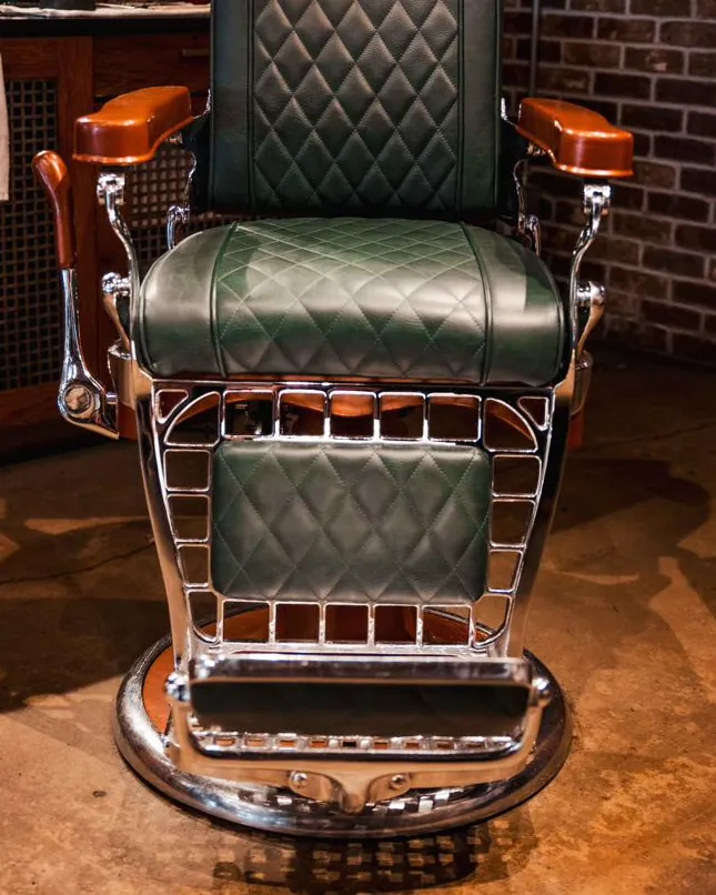 A green leather barber chair
