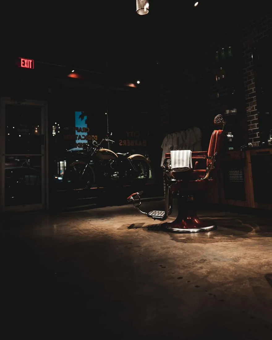 The shop floor after hours, with a red barber chair in the distance
