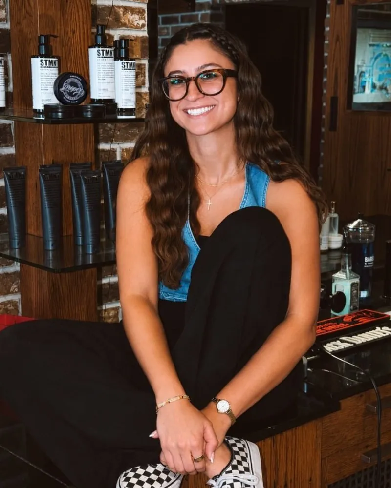 Sophia, a barber at City Barbers, at her station