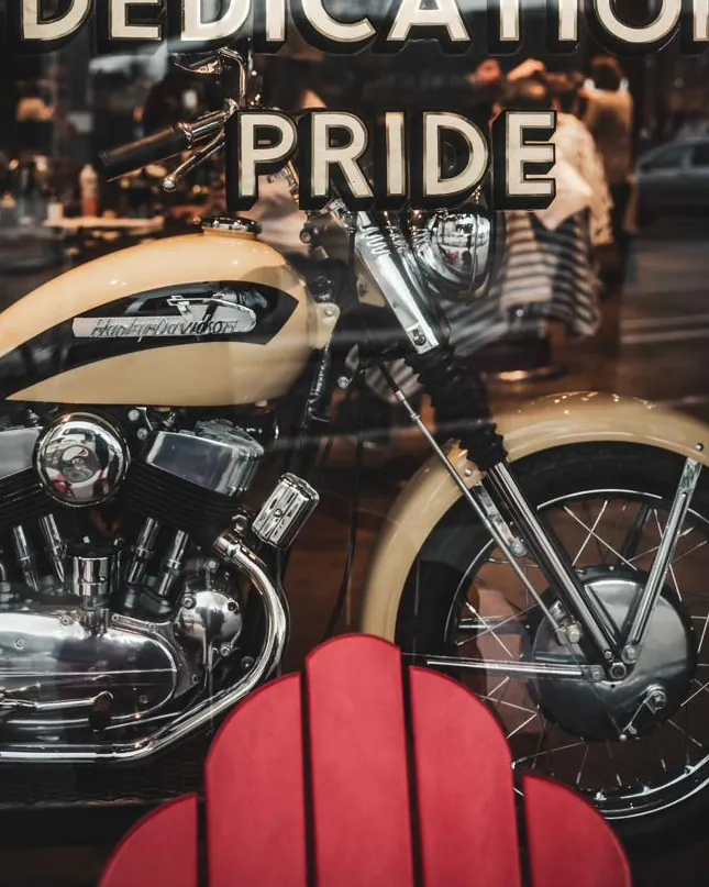A vintage motorcycle beneath the shop window