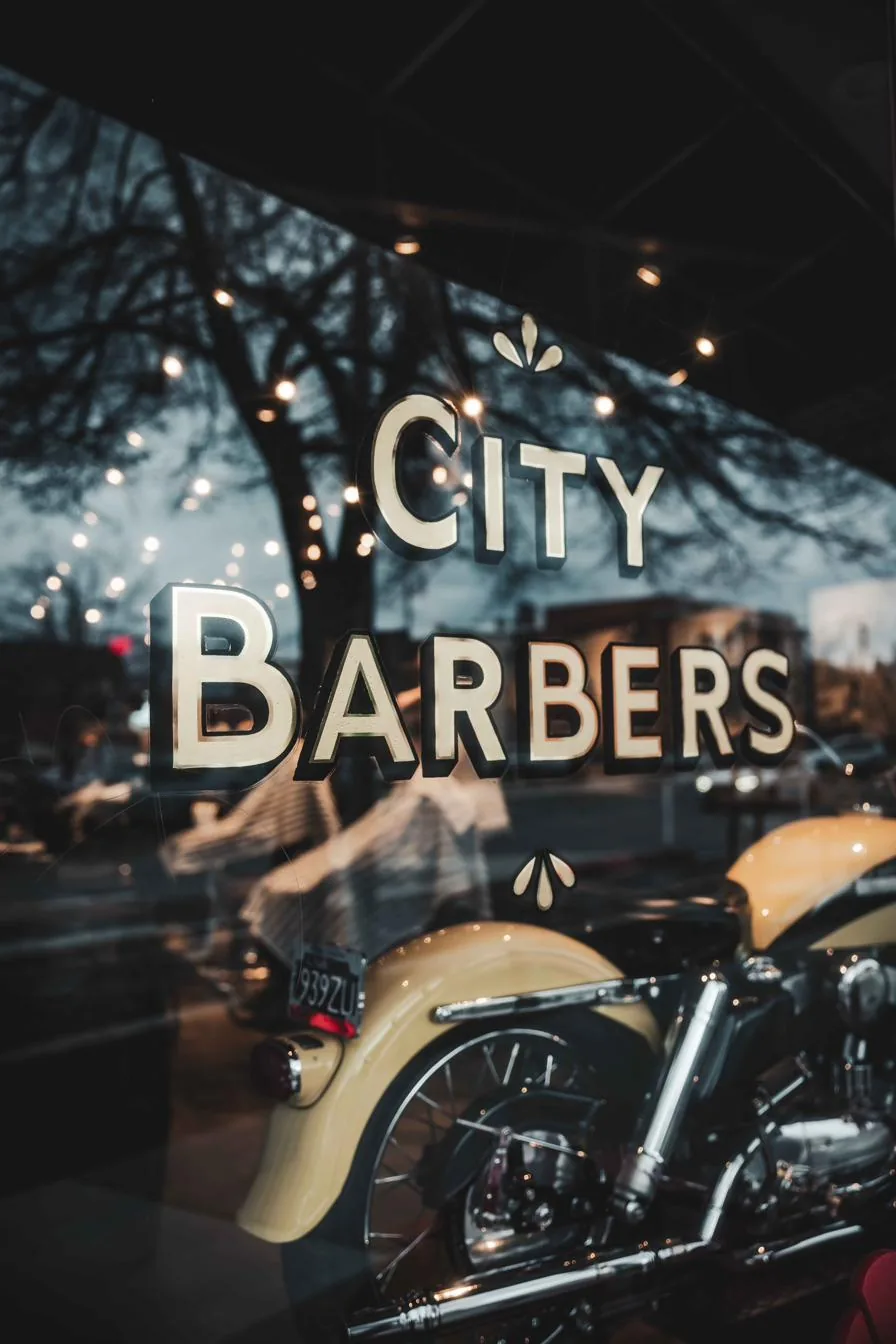 Gold City Barbers lettering on the shop’s front window